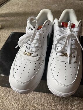 Nike White Low-Top Sneakers with Green Swoosh and Gold Lace Charm